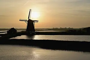 Texel Island Netherlands Drucke: Historic windmill in the light of the setting sun