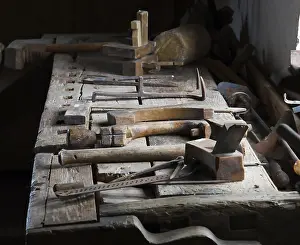 Traditional Craftsmanship Images Drucke: Historic working bench in an old joiner workshop with old tools