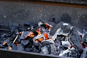 Deserted Barbecue Scene Drucke: Hot glowing charcoal with sparks and flames