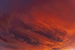 Overcast Cloudy Skies Europe Drucke: Huge orange cloud in the sky at sunset