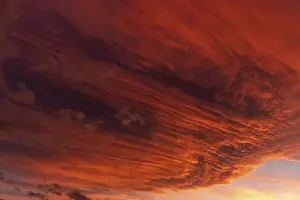 Deserted Sunset Landscape Drucke: Huge orange cloud in the sky at sunset
