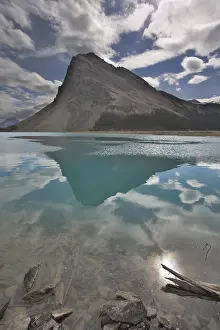 Deserted Waterfront Landscape Drucke: The huge rock of the triangular form is reflected in emerald waters of cold mountain lake