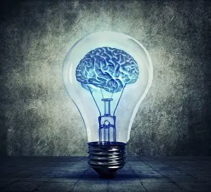 Light Bulb Concept Drucke: Human brain glowing inside a light bulb