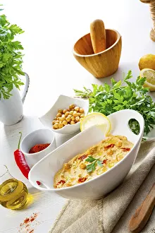 Healthy Snack Ideas Drucke: Hummus paste with lemon and chilli on a white background