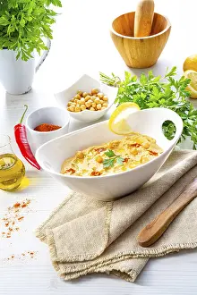 Arabic Cuisine Inspiration Drucke: Hummus paste with lemon and chilli on a white background