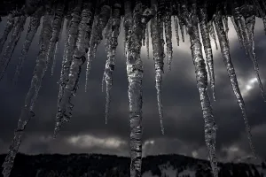 Dark Sky Germany Drucke: Icicle on gutter in front of dark sky
