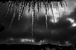 Dark Sky Germany Drucke: Icicle on gutter in front of dark sky