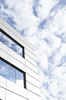 Urban Cityscape View Drucke: An image capturing a segment of a modern building's exterior featuring angular white panels