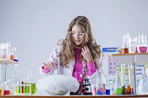 Little Girl Scientist Drucke: Image of cute student watching over experiment in lab