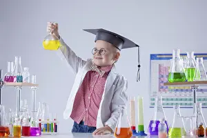 Medical Education Drucke: Image of little chemist posing with variety of reactants