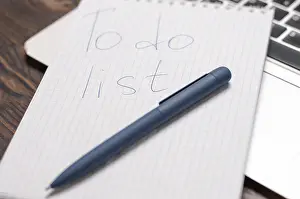 Creative Workspace Inspiration Drucke: Image of a notebook with a pen lying on a laptop