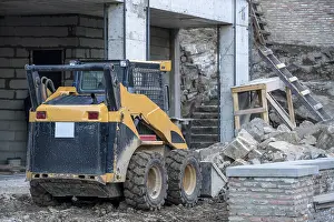 Building Site Machinery Drucke: Image of skid loader working on building construction