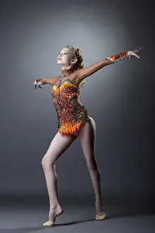 Active Young Woman Drucke: Image of young artistic gymnast performs in studio