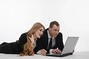 Teamwork And Technology Drucke: Two individuals engaged in a collaborative activity