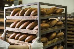 Freshly Baked Goods Images Drucke: Industrial bakery with fresh bread on racks