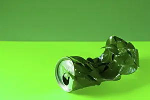 Environmental Pollution Control Drucke: Infolded can with green leafs; concept for recycling