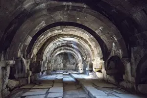 Ancient Armenian Architecture Drucke: Interior view of an ancient stone vaulted structure with heavy shadow