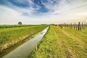 Agricultural Field Photography Drucke: Irrigation canal runs through the fields in the countryside of Romagna