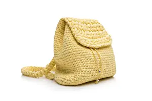 Bright White Background Drucke: Isolated view of small yellow knitted backpack