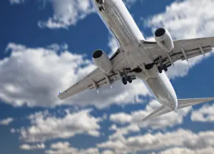 Deserted Airport Scene Drucke: Jet airplane landing with dramatic clouds and sky behind