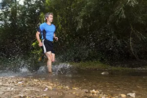 Recreational Activity Germany Drucke: Jogger running through a stream