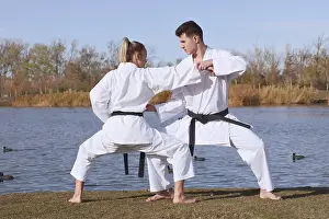 Lake Scenery Photography Drucke: Karate experts practice combat techniques by a tranquil lake