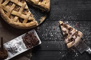 Kitchen Table Setup Drucke: Kitchen table with a whole apple pie and one slice on a knife
