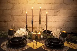 Romantic Dinner Setup Drucke: The laid table with a dinner and candlesticks by romantic candlelight