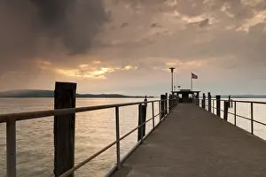 Evening Light On Water Drucke: Lake Constance and approaching thunder clouds in the evening
