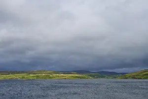 Northern Europe Nature Shots Drucke: Lake with dramatic clouds and green rolling hills in the background