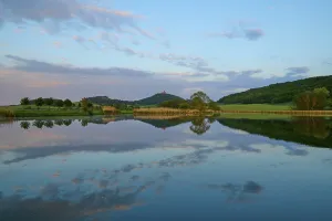 Thuringia Landscape Photography Drucke: Lake with reflection in spring with castle at sunset