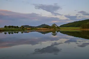 European Fortification Architecture Drucke: Lake with reflection in spring with castle at sunset