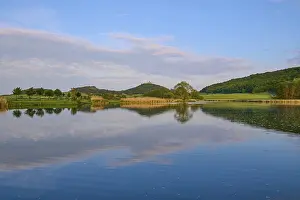 European Fortification Architecture Drucke: Lake with reflection in spring with castle at sunset
