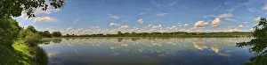 Cloudy Sky Landscapes Drucke: Landscape of Danubia river with reflection of the landscape and Clouds