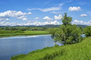 Danube River Landscape Drucke: Landscape of Danubia river with reflection of the landscape and Clouds