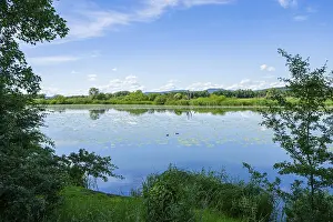 Danube River Landscape Drucke: Landscape of Danubia river with reflection of the landscape and Clouds