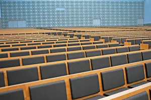 Sacred Building Structure Drucke: Large auditorium with geometric patterns on the wall and many rows of seats