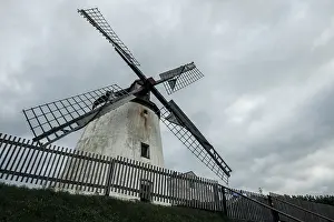 Podersdorf Am See Landscape Drucke: Large historic windmill under a cloudy sky