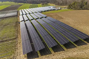 Renewable Energy Supply Germany Drucke: Large-scale solar system on arable land with adjacent trees and fields