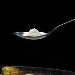 Sterling Silver Cutlery Set Drucke: A LARGE SPOON OF SALT AROUND THE POT ON A DARK BACKGROUND