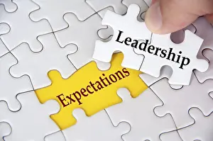 Team Collaboration Strategy Drucke: Leadership Expectations, Jigsaw puzzle with missing piece showing the text Leadership Expectations highlighted in focus