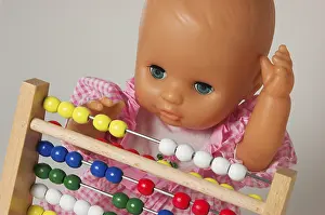 Educational Institution Concept Drucke: Learning arithmetics, doll using an abacus