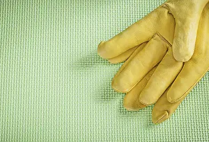 Green Background Studio Shot Drucke: Leather protective gloves on green background construction concept