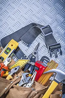 Metal Background Studio Shot Drucke: Leather tool belt with construction objects on corrugated metal pattern maintenance concept