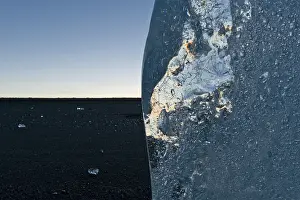 Turquoise Glacier Lake Drucke: Light reflections in a stranded piece of iceberg after sunset