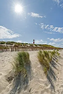 Backlit Lighthouse Photo Drucke: Lighthouse with blue sky, sun, backlight at Ellenbogen