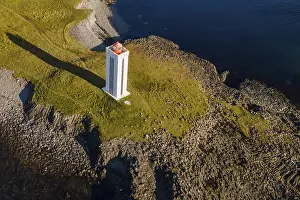 Uninhabited Island State Landscapes Drucke: Lighthouse and coastal landscape with basalt formations