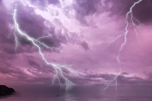 Stormy Atmosphere Europe Drucke: Lightning over the sea with a dramatic sky