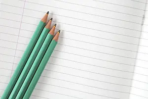 Lined exercise book and three pencils