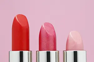 Cosmetic Product Display Drucke: Lipsticks lined up in a rows against pink